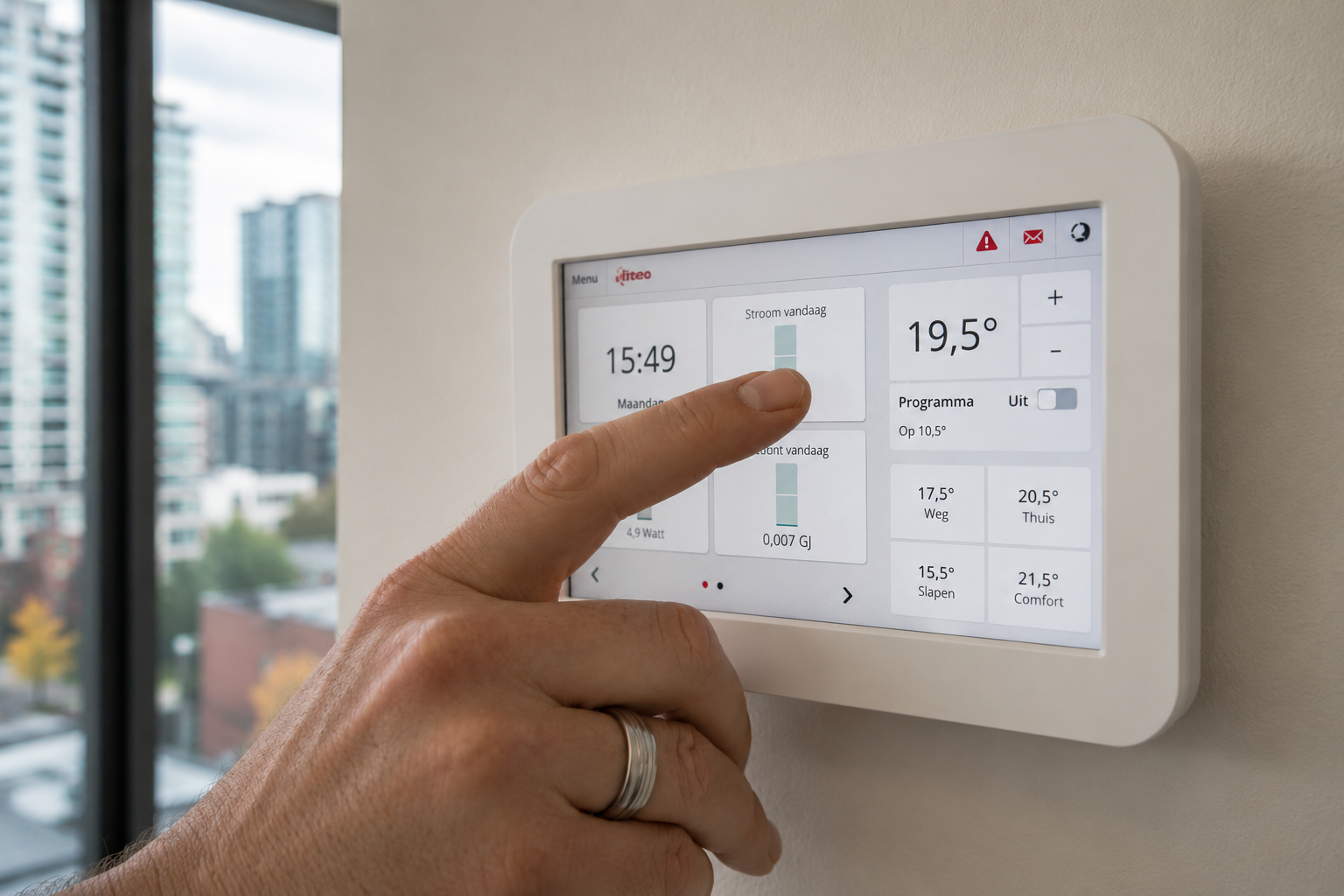 Hand adjusting a modern wall-mounted thermostat — the controls layer of the systems we design.